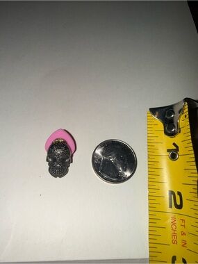 Black skull pin with ornate detailing and pink backing #skull #ornate